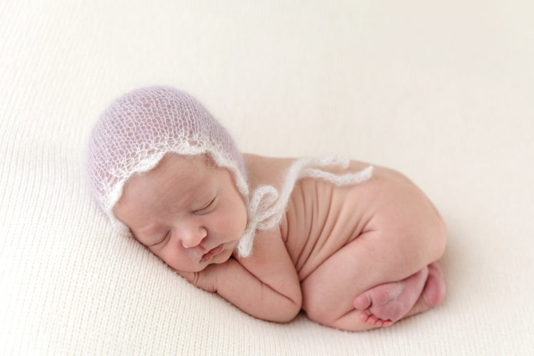 Newborn girl with bonnet